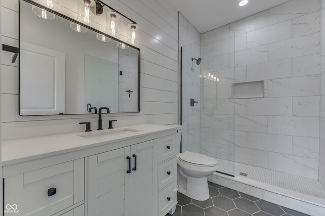 2144 Connie Ct, Franklin, IN 46131 - bathroom featuring a tile shower, toilet, vanity, tile patterned flooring, and recessed lighting