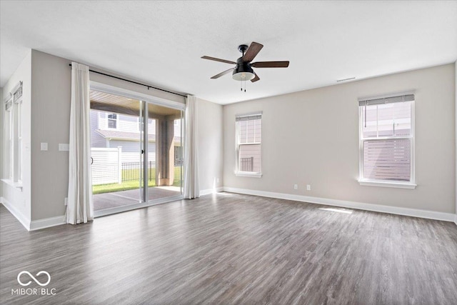 7012 Pickett Pl, Carmel, IN 46033 - empty room featuring dark wood-style floors, ceiling fan, and baseboards