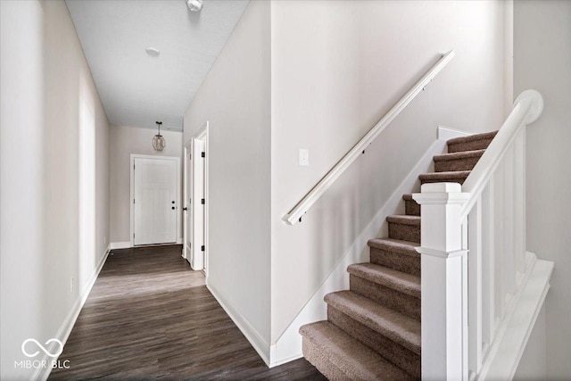 7012 Pickett Pl, Carmel, IN 46033 - stairway featuring wood finished floors and baseboards