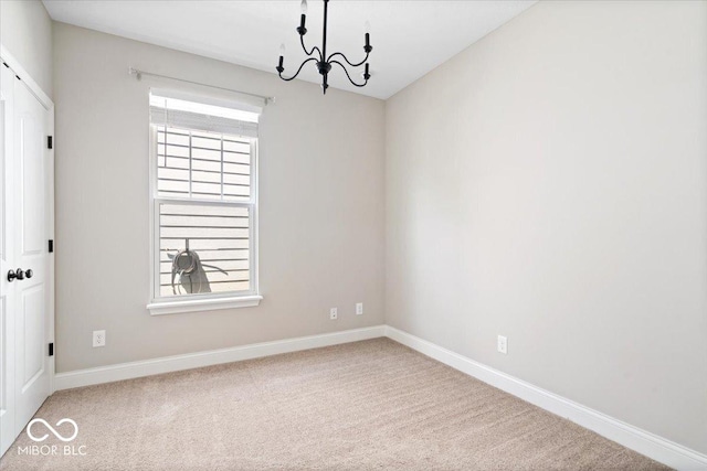 7012 Pickett Pl, Carmel, IN 46033 - empty room featuring a chandelier, baseboards, and carpet floors