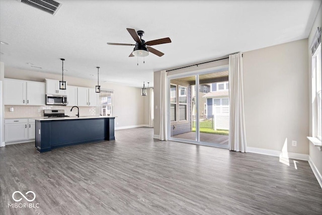 7012 Pickett Pl, Carmel, IN 46033 - unfurnished living room with ceiling fan, dark wood-style flooring, baseboards, and a sink