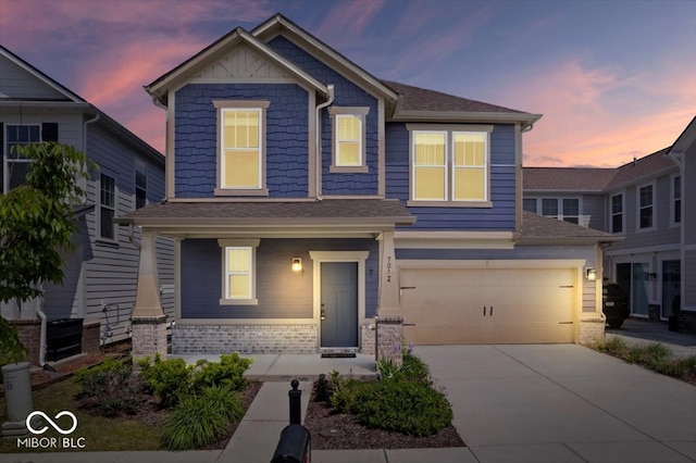 7012 Pickett Pl, Carmel, IN 46033 - craftsman-style home featuring a porch, concrete driveway, an attached garage, and a shingled roof