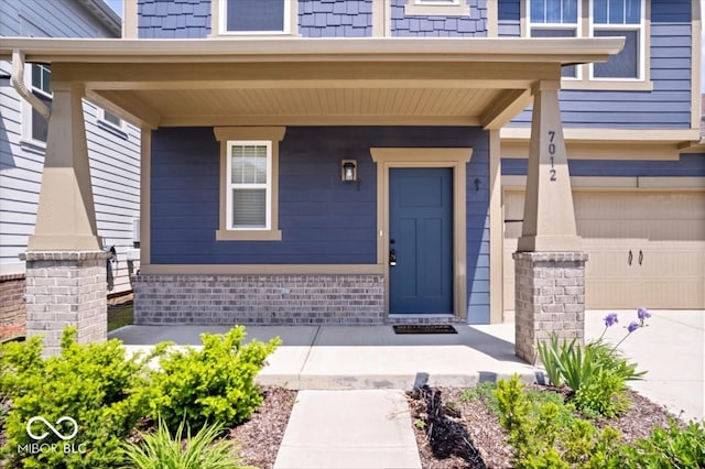 7012 Pickett Pl, Carmel, IN 46033 - property entrance featuring a porch, an attached garage, and driveway