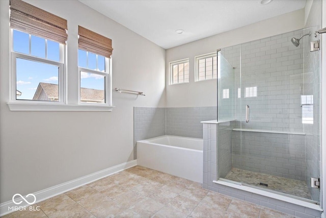 7012 Pickett Pl, Carmel, IN 46033 - full bathroom featuring a shower stall, baseboards, and a bath