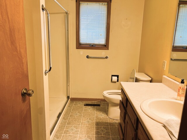 8809 Jonathon Pl, New Haven, IN 46774 - bathroom featuring a shower stall, vanity, toilet, tile patterned flooring, and baseboards