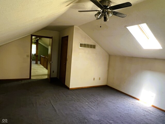 8809 Jonathon Pl, New Haven, IN 46774 - additional living space with carpet, lofted ceiling, baseboards, a skylight, and a textured ceiling