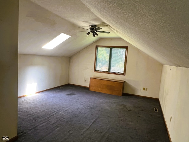 8809 Jonathon Pl, New Haven, IN 46774 - bonus room featuring carpet flooring, lofted ceiling, a ceiling fan, a textured ceiling, and baseboards