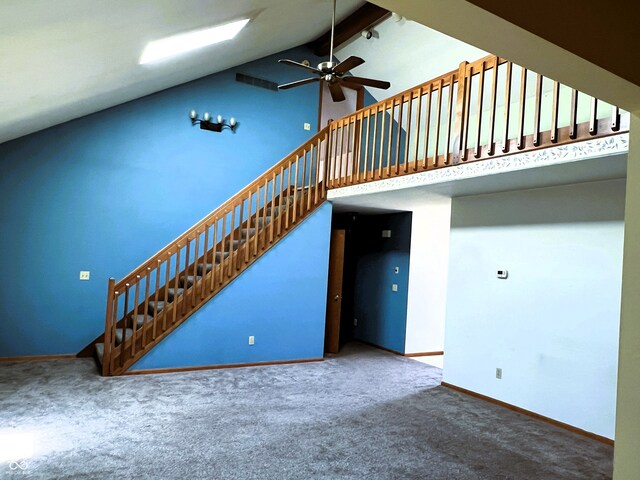 8809 Jonathon Pl, New Haven, IN 46774 - unfurnished living room with beamed ceiling, carpet, baseboards, a ceiling fan, and high vaulted ceiling