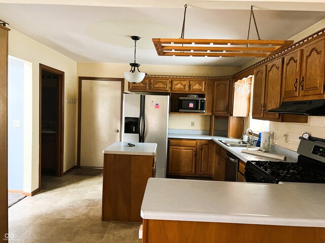 8809 Jonathon Pl, New Haven, IN 46774 - kitchen with under cabinet range hood, appliances with stainless steel finishes, decorative backsplash, and a sink