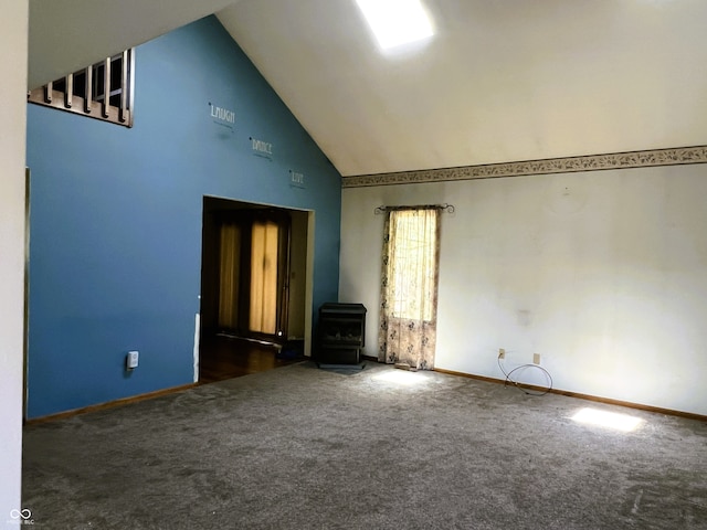 8809 Jonathon Pl, New Haven, IN 46774 - carpeted spare room featuring a wood stove, high vaulted ceiling, and baseboards