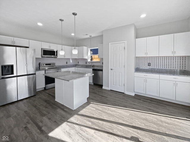 8251 Garden Ridge Rd, Indianapolis, IN 46237 - kitchen with pendant lighting, decorative backsplash, white cabinetry, and stainless steel appliances