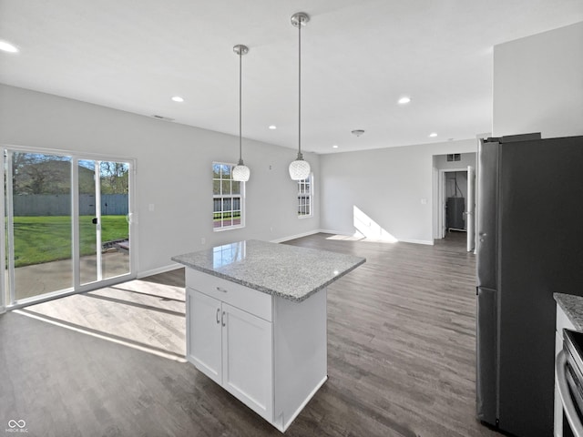 8251 Garden Ridge Rd, Indianapolis, IN 46237 - kitchen featuring recessed lighting, open floor plan, freestanding refrigerator, dark wood-type flooring, and decorative light fixtures