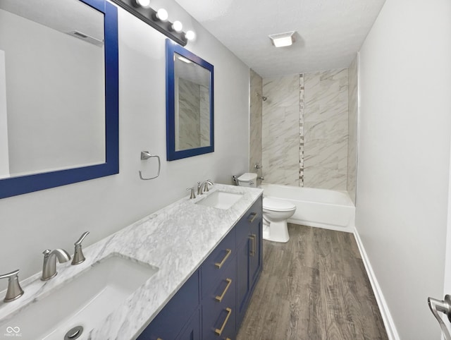 8251 Garden Ridge Rd, Indianapolis, IN 46237 - bathroom with toilet, wood finished floors, a sink, and shower / bathtub combination