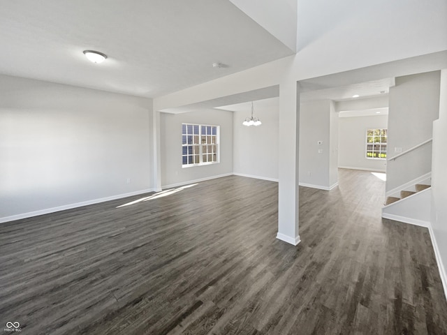 8251 Garden Ridge Rd, Indianapolis, IN 46237 - unfurnished living room with stairway, dark wood-style flooring, baseboards, and an inviting chandelier