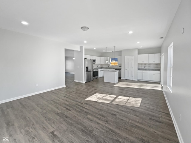 8251 Garden Ridge Rd, Indianapolis, IN 46237 - unfurnished living room featuring baseboards, dark wood finished floors, and recessed lighting