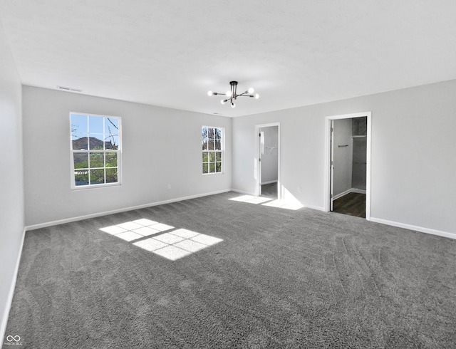 8251 Garden Ridge Rd, Indianapolis, IN 46237 - unfurnished bedroom with a notable chandelier, baseboards, a spacious closet, visible vents, and carpet