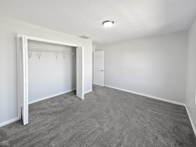 8251 Garden Ridge Rd, Indianapolis, IN 46237 - unfurnished bedroom with a closet, dark colored carpet, visible vents, and baseboards