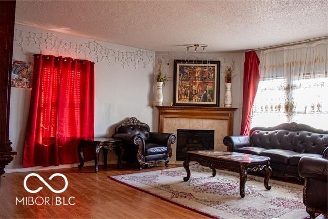10105 Yosemite Ln, Indianapolis, IN 46234 - living room featuring a fireplace, wood finished floors, and a textured ceiling