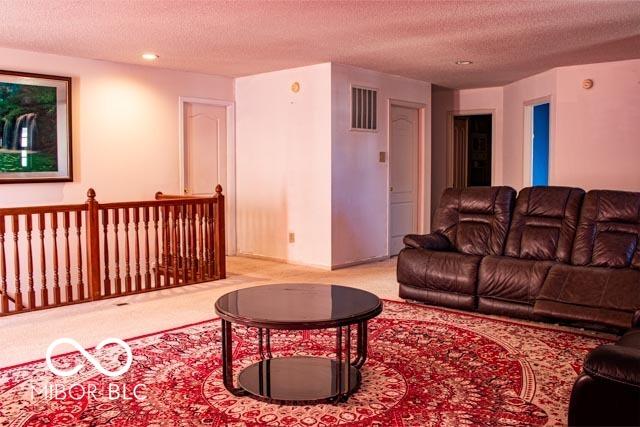 10105 Yosemite Ln, Indianapolis, IN 46234 - carpeted living area featuring recessed lighting, visible vents, and a textured ceiling