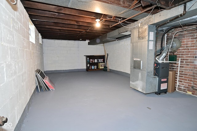 unfinished basement featuring heating unit