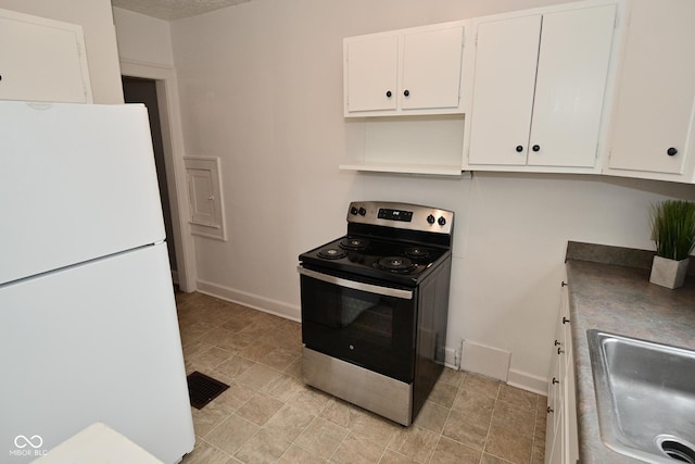 kitchen with baseboards, a sink, freestanding refrigerator, stainless steel electric stove, and white cabinetry