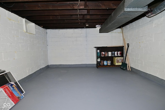 unfinished below grade area featuring concrete block wall