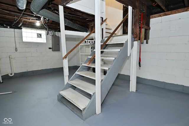 below grade area featuring electric panel and stairway