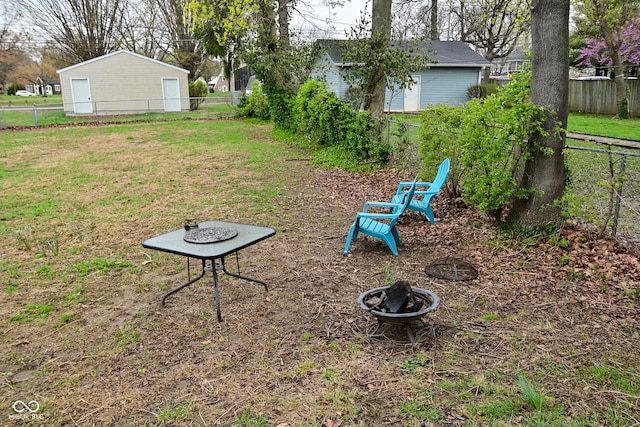 view of yard featuring an outdoor fire pit and a fenced backyard