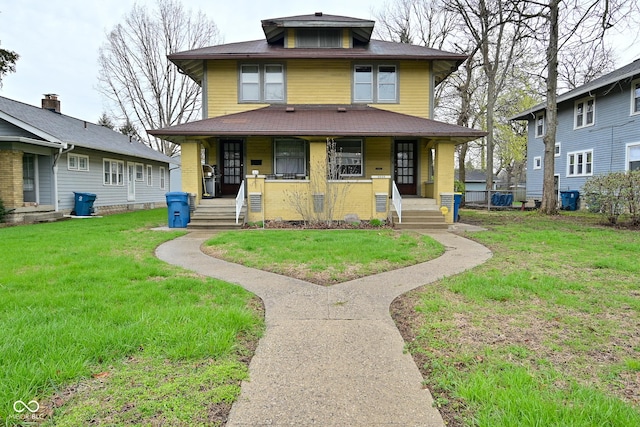 traditional style home featuring a front yard and covered porch