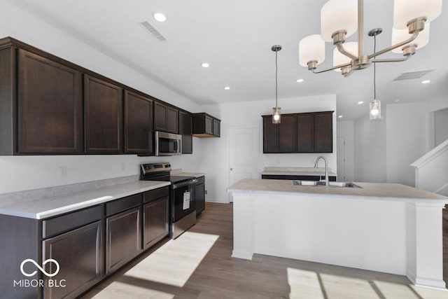 1117 Stubble Run, Danville, IN 46122 - kitchen with stainless steel appliances, dark brown cabinets, light wood finished floors, recessed lighting, and pendant lighting