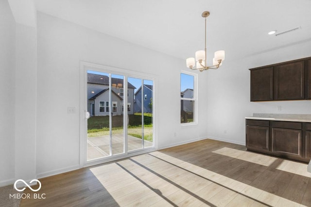 1117 Stubble Run, Danville, IN 46122 - unfurnished dining area with light wood-style flooring and a chandelier