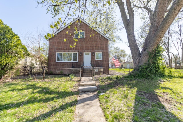 view of front facade with a front yard, brick siding, and a fenced front yard