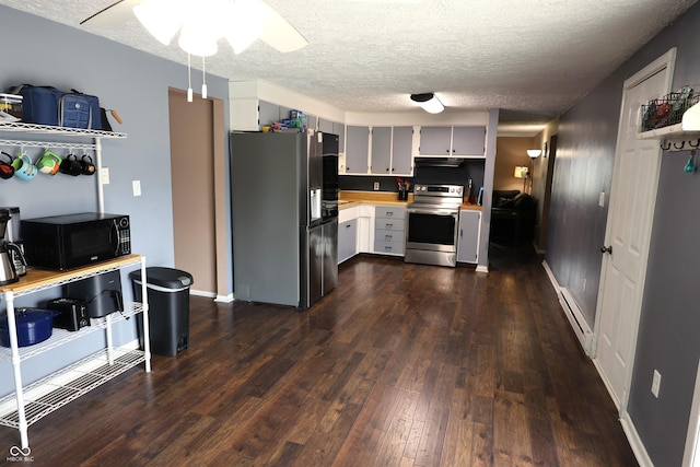 kitchen featuring light countertops, appliances with stainless steel finishes, ceiling fan, a textured ceiling, and dark wood-style floors