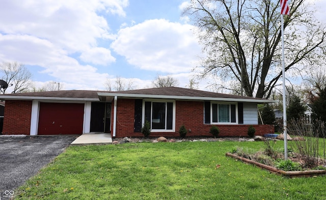single story home featuring brick siding, a front yard, a garage, and aphalt driveway