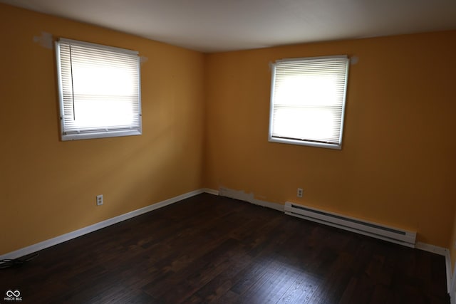 unfurnished room featuring dark wood-style flooring, a baseboard radiator, and baseboards