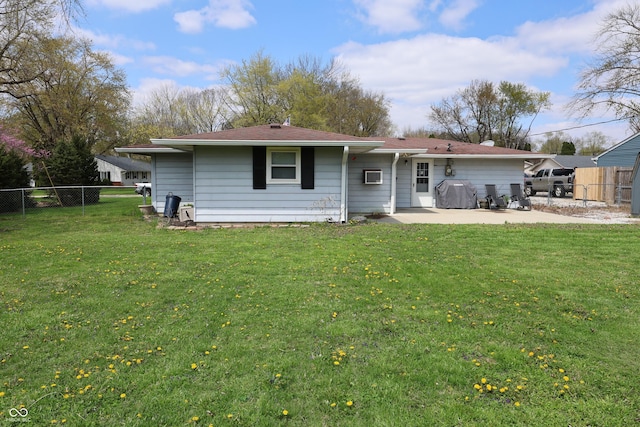 rear view of property with a yard, a patio area, and fence