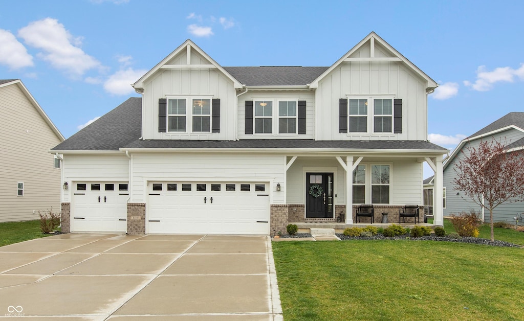 craftsman-style home featuring a porch, driveway, board and batten siding, and a front lawn