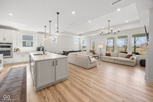 7210 Covington St, Lebanon, IN 46052 - kitchen with light wood finished floors, a chandelier, stainless steel double oven, and recessed lighting