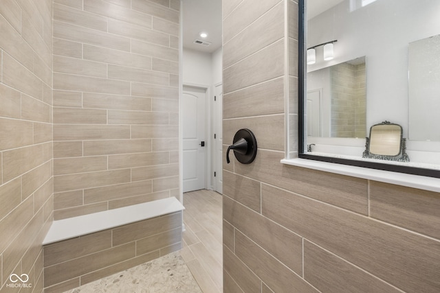 7210 Covington St, Lebanon, IN 46052 - full bathroom featuring visible vents, a tile shower, and tile walls
