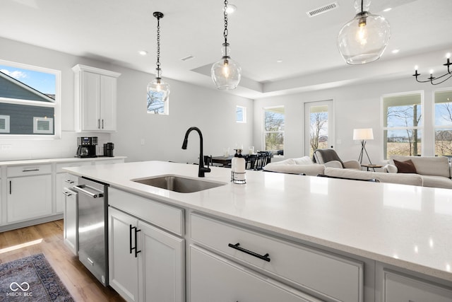 7210 Covington St, Lebanon, IN 46052 - kitchen with open floor plan, light wood-style flooring, decorative light fixtures, visible vents, and a sink