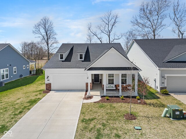 7210 Covington St, Lebanon, IN 46052 - view of front of property with concrete driveway, an attached garage, a front yard, brick siding, and a porch