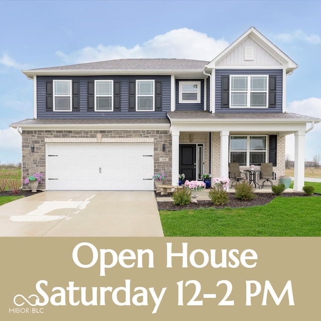 2538 Redding Dr, Whitestown, IN 46075 - view of front of house featuring an attached garage, covered porch, concrete driveway, board and batten siding, and a front lawn