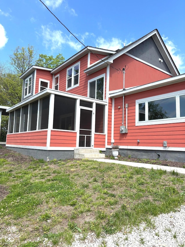 359 N Jefferson St, Martinsville, IN 46151 - rear view of house featuring a sunroom and a lawn