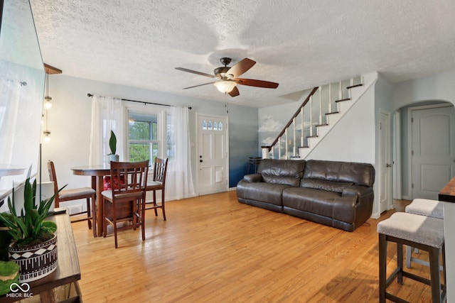 5945 Mcfarland Rd, Indianapolis, IN 46227 - living room featuring stairway, light wood finished floors, a textured ceiling, and ceiling fan
