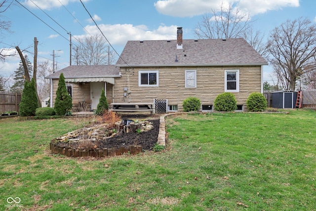 5945 Mcfarland Rd, Indianapolis, IN 46227 - back of house with a yard, fence, a shingled roof, and a chimney