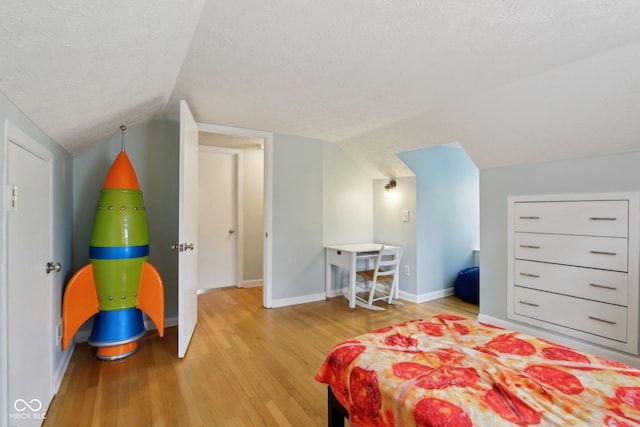 5945 Mcfarland Rd, Indianapolis, IN 46227 - bedroom featuring a textured ceiling, wood finished floors, baseboards, and lofted ceiling