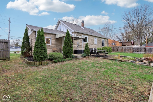 5945 Mcfarland Rd, Indianapolis, IN 46227 - rear view of house with a yard, a patio area, fence, and a chimney