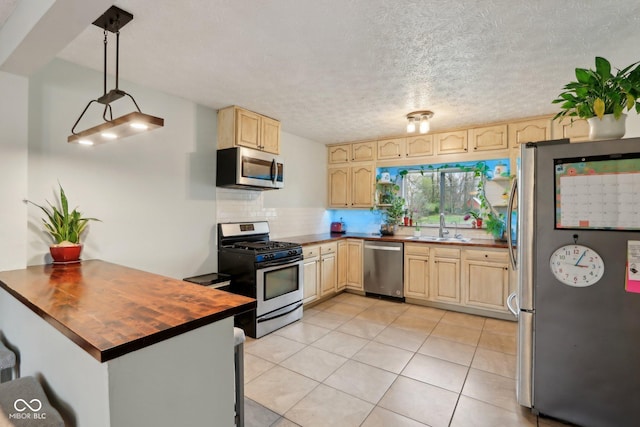 5945 Mcfarland Rd, Indianapolis, IN 46227 - kitchen with light brown cabinetry, appliances with stainless steel finishes, a sink, wood counters, and backsplash