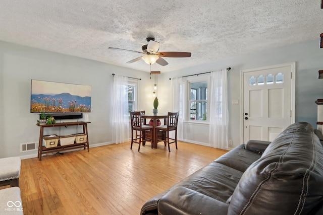 5945 Mcfarland Rd, Indianapolis, IN 46227 - living room with visible vents, a ceiling fan, light wood-style floors, and a textured ceiling