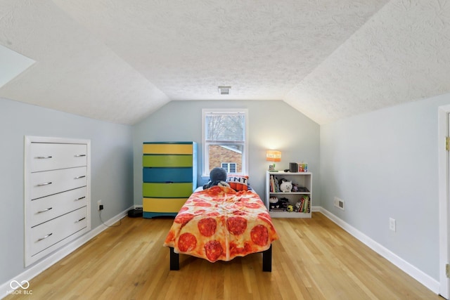 5945 Mcfarland Rd, Indianapolis, IN 46227 - bedroom with lofted ceiling, a textured ceiling, baseboards, and wood finished floors